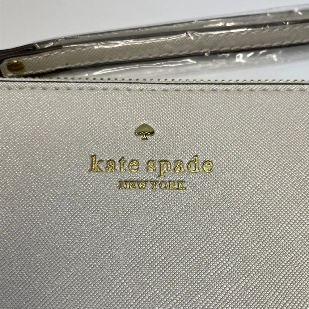 NWT Kate Spade cream saffiano wristlet with gold logo.  8x5” - Picture 2 of 7